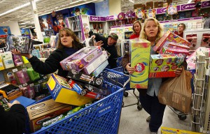 FORT WORTH, TX - NOVEMBER 27: Shoppers Jeri Hull (L) and Karen Brashear (R) wait in line while shopping at Toys"R"Us during the Black Friday sales event on November 27, 2009 in Fort Worth, Texas. Toys"R"Us stores nationwide opened at midnight Thursday, November 26, providing shoppers access to its Black Friday deals five hours earlier than ever before. According to the National Retail Federation, a trade organization, as many as 134 million people, 4.7% more than last year, will shop this Friday, Saturday or Sunday. (Photo by Tom Pennington/Getty Images)